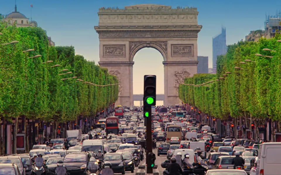 Traffic With Arc De Triomphe In Background Day Time